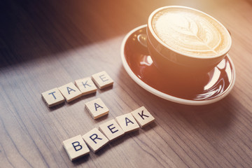 Cup of coffee on workplace desk, take a breake.