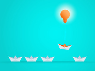 Outstanding the Boat rises above with light bulb idea. Business advantage opportunities and success concept. Uniqueness, leadership, independence, initiative, strategy, dissent, think different.