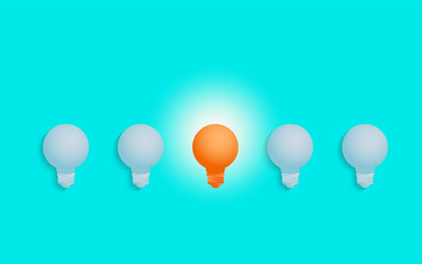 Stand out from the crowd. Outstanding unique orange light bulb glowing. Business success concept. Uniqueness, leadership, independence, initiative, strategy, dissent, think different.