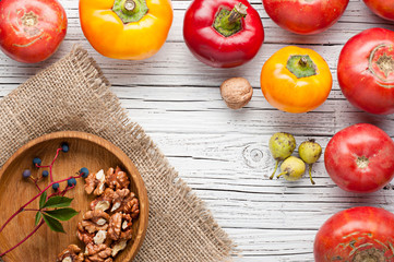 organic farm tomatoes on wooden background  top view, frame, copy space