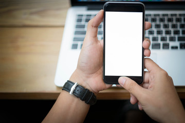 Cropped shot view of woman's hands holding smart phone with blank copy space screen for your text message or information content, female reading text message on cell telephone during in urban setting