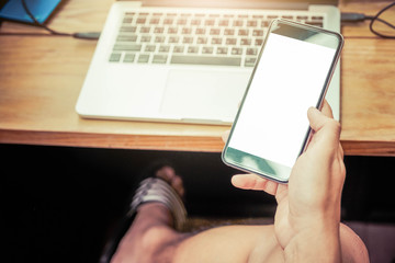 Cropped shot view of woman's hands holding smart phone with blank copy space screen for your text message or information content, female reading text message on cell telephone during in urban setting
