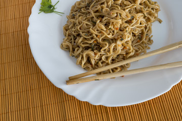 Yakisoba / noodles with beef in rectangle plate with bamboo stic