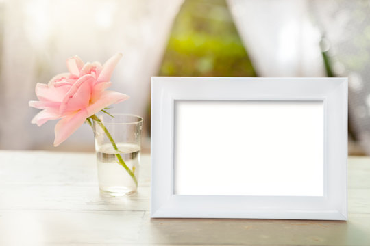 White frame mockup with rose in glass