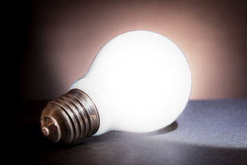 a lamp glowing on a black table
