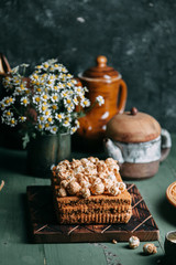 honey on a wooden Board with sweet popcorn. Composition with flowers on the table in the dark key