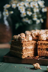 honey on a wooden Board with sweet popcorn. Composition with flowers on the table in the dark key