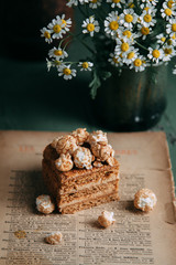 honey on a wooden Board with sweet popcorn. Composition with flowers on the table in the dark key