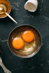 The process of cooking pancakes on a black background and set of ingredients