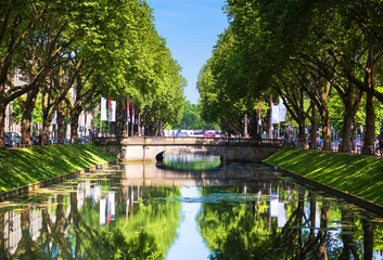 Panoramic view on Konigsallee or King’s Avenue, which is one of the most famous touristic places in Dusseldorf and Germany. Scenic landscape with the German urban boulevard. © vladhhe