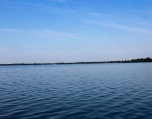 The blue looking lake and the blue sky background.