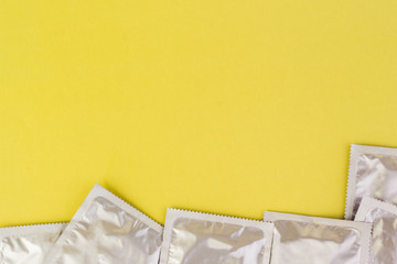 Condoms on a yellow background