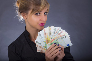 Girl with stack of euro bank notes