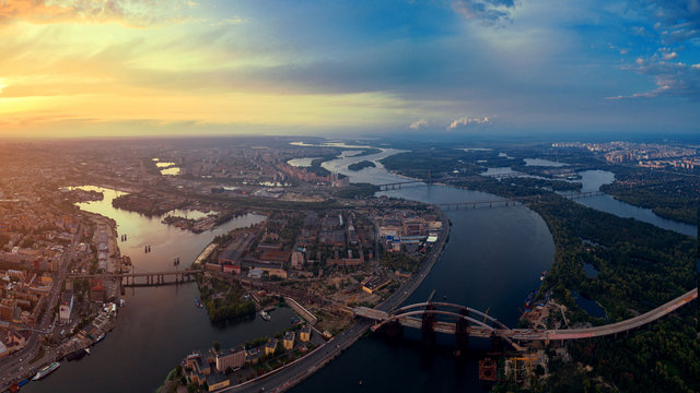 Panoramic aerial view of the old part of the city - Podol district. View of the Rybalsky Island at sunset.
