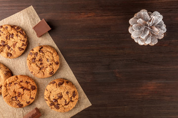 Chocolate chips cookies, snowy pine cone, copy space