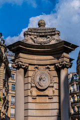 Monumental fountain (1900) occupies center square of Place Georges Mulot in Paris. It is decorated with 4 medallions representing Georges Mulot (engineer), Rosa Bonheur, Dr. Bouchut and Hauy Valentin.