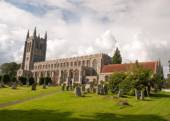 amazing full frontal summer view of old english church in long melford with cemetery in front