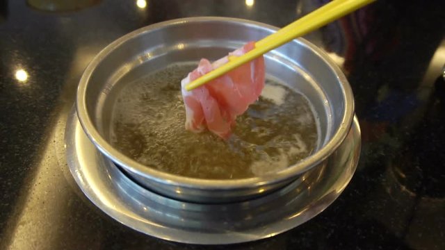 Close up of delicious thai food soup cooking with hand pock in restaurant. Super slow motion 120 fps
