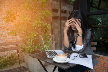 Tired businesswoman having a headache due to bankruptcy. Sleepy employee overworking making mistake. Business concept.