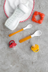 children feeding with breastmilk or infant formula powdered baby milk and toys on gray background top view mockup