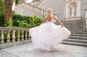 Fototapeta premium bride in a dress is spinning in a dance