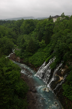 Beautiful Shirogane Falls dropping into a blue river, Biei, Hokkaido, Japan