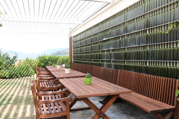 Summer garden in the well-known winery. wooden chairs and glass flasks.