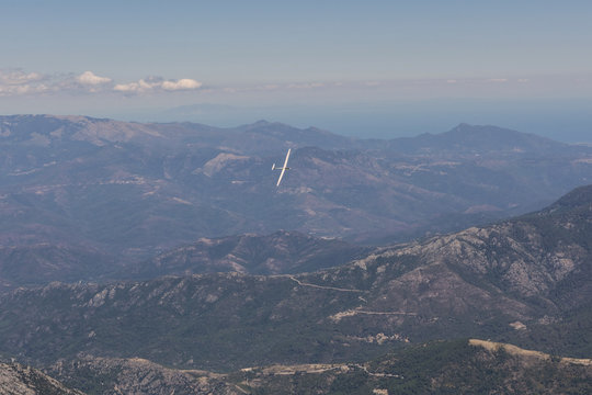 view of the sailplane flying over the mountains of Corsica