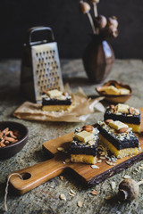 Sponge cake with poppy seed layer, decorated with white chocolate curls and sliced almond