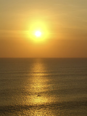 Fototapeta premium a fishing boat sails at the coast of Bali to home