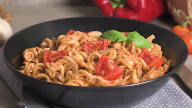 Italian Pasta with Tuna and Basil. Fresh pasta with tuna and tomato sauce on old wooden background.