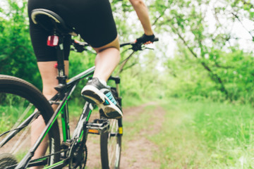 Woman riding a mountain bike in the forest
