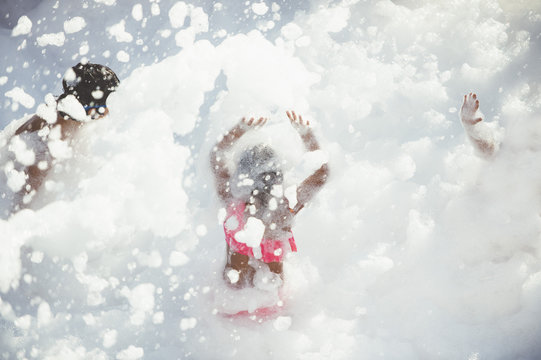 Children playing in foam