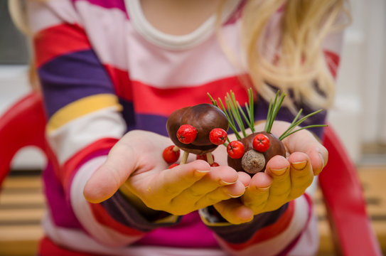 creative child with home made autumn craft