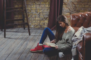 Beautiful woman reading a book wearing warm clothing. Relax time during cold weather