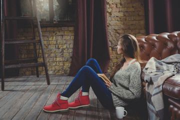 Beautiful woman reading a book wearing warm clothing. Relax time during cold weather