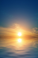 Dawn, the sun is in the sky and cirrus clouds on the sea.