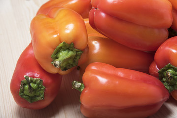 Pile of sweet pepper on a wooden table