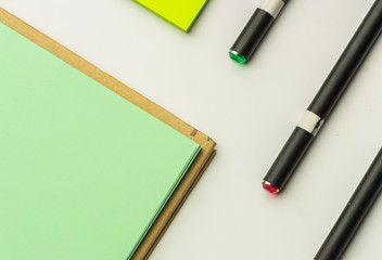 Modern samples of stationery, notebooks, stickers and pencils.