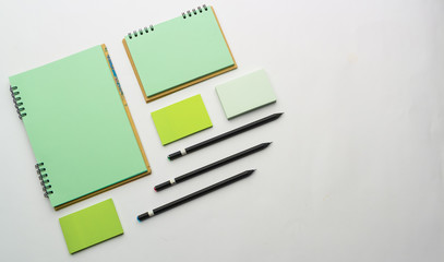 Modern samples of stationery, notebooks, stickers and pencils.