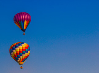 Naklejka premium Two Colorful Balloons Against Blue Sky Background