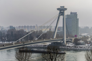 Snow and cold fog on the new bridge in Bratislava