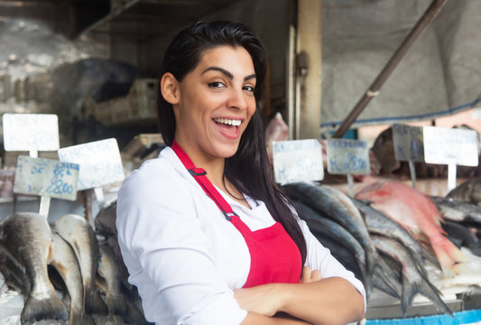 Happy Woman Selling Fresh Fish On A Latin Fish Market