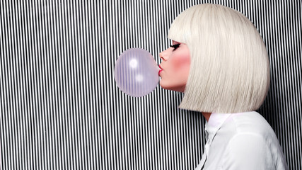 Beautiful girl in white wig blew up in pink gum bubble. A young girl in the studio on a background...