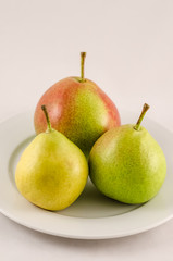 Ripe pears on the white background