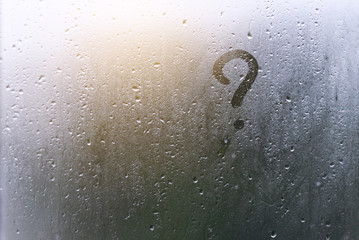Rainy weather, the inscription on the sweaty glass question mark.
