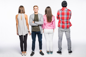 Fototapeta premium Reir view of a casual group of people with a man facing the camera isolated on white