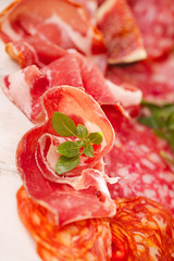 antipasti Platter of Cured Meat,   jamon, sausage, salame on white wood