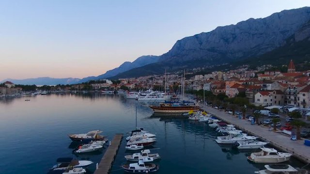 Aerial view on Makarska and marina at sunrise with Biokovo mountain in background. Makarska Riviera, Croatia 