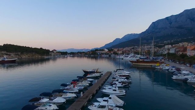 Aerial view on Makarska and marina at sunrise with Biokovo mountain in background. Makarska Riviera, Croatia 
